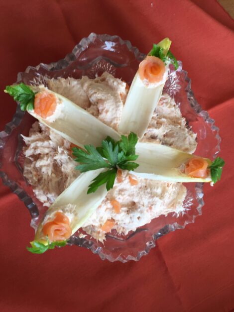Smoked salmon pate decorated with endive and salmon roses.