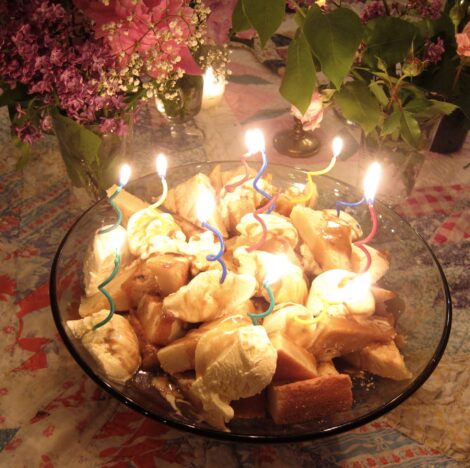 A Sweet Leisure Cake lit with candles.
