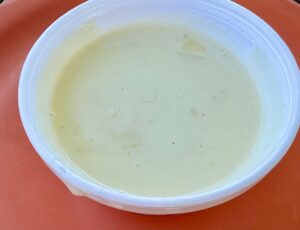D'Arcy's cheese sauce in a take-out container.