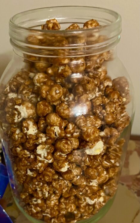 Caramel corn in a glass jar.