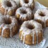 Six mini lemon bunt cakes on a doily.