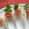 A plate of smoked salmon roses sitting in endive
