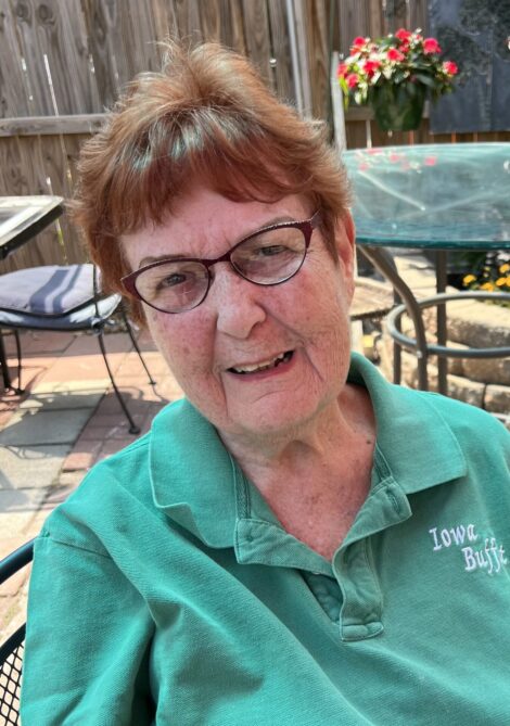 Red-headed Carolyn McKinney wearing an Iowa Buffet shirt.