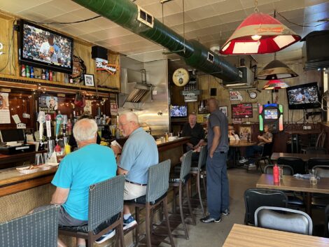 Customers sitting at the bar at Iowa Buffet.