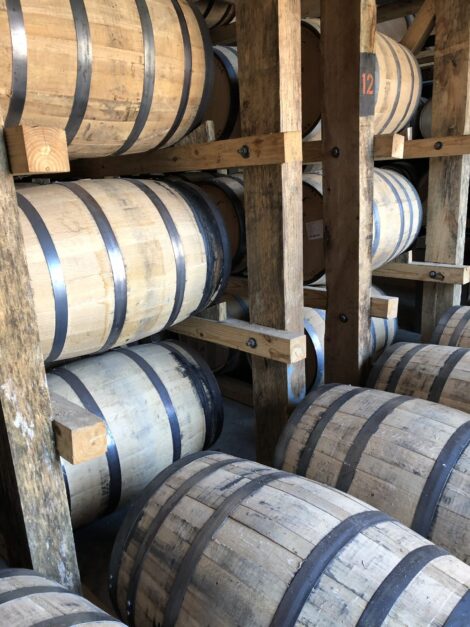 A stack of new oak barrells holding bourbon