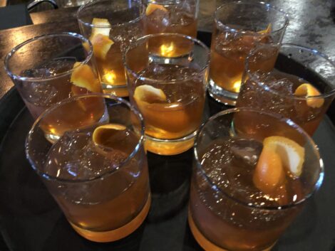 A tray filled with Old Fashioned cocktails.