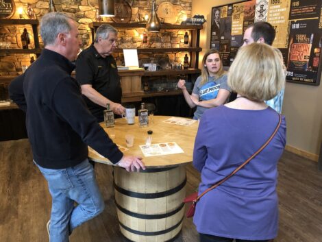 Visitors discuss bourbon with a distiller.