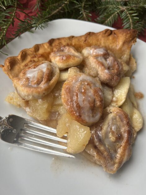 A wedge of Princess :era Cinnamon Roll Apple Pie