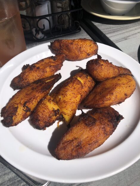 An order of sweet fried plantains sitting on a white plate.