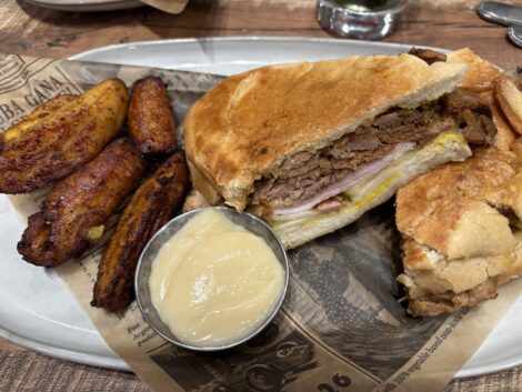 A half of Cuban sandwich and caramelized plantains as served at Havana' Cuisine